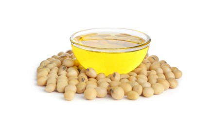 Photo of Glass bowl of oil with soybeans on white background