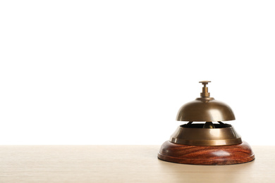 Photo of Hotel service bell on wooden table against white background