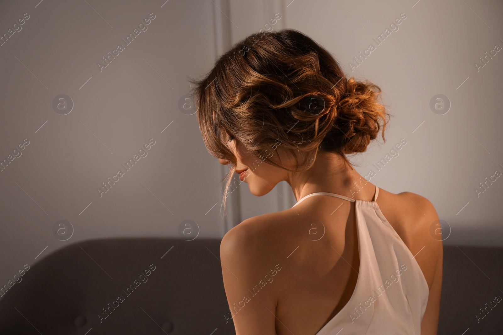 Photo of Young woman with beautiful hairstyle indoors. Space for text