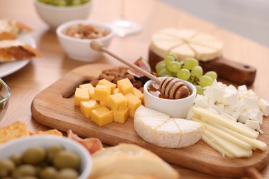 Photo of Assorted appetizers served on wooden table, closeup