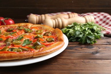 Photo of Delicious pizza Diablo and ingredients on wooden table, closeup. Space for text