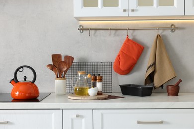 Set of different utensils and dishes on countertop in kitchen