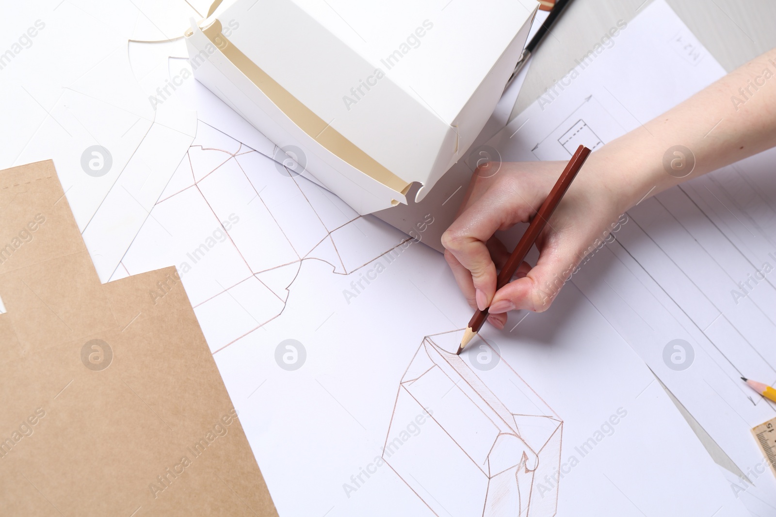 Photo of Woman creating packaging design at table, top view