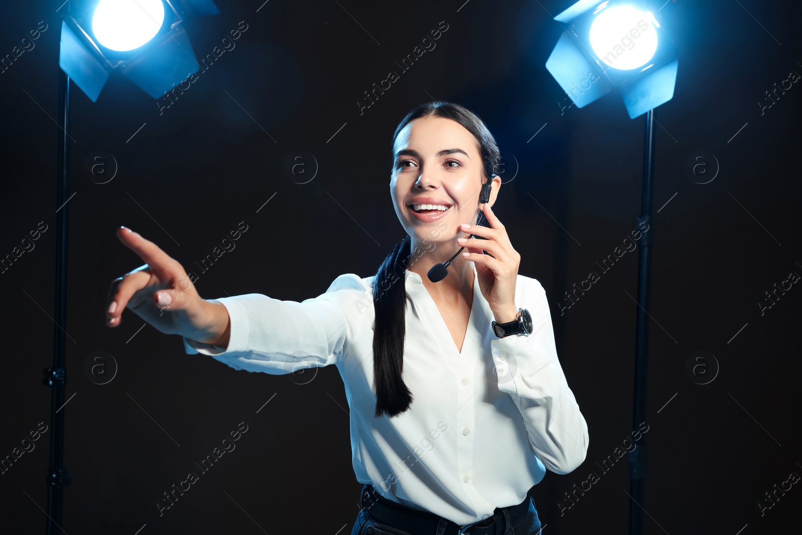 Photo of Motivational speaker with headset performing on stage