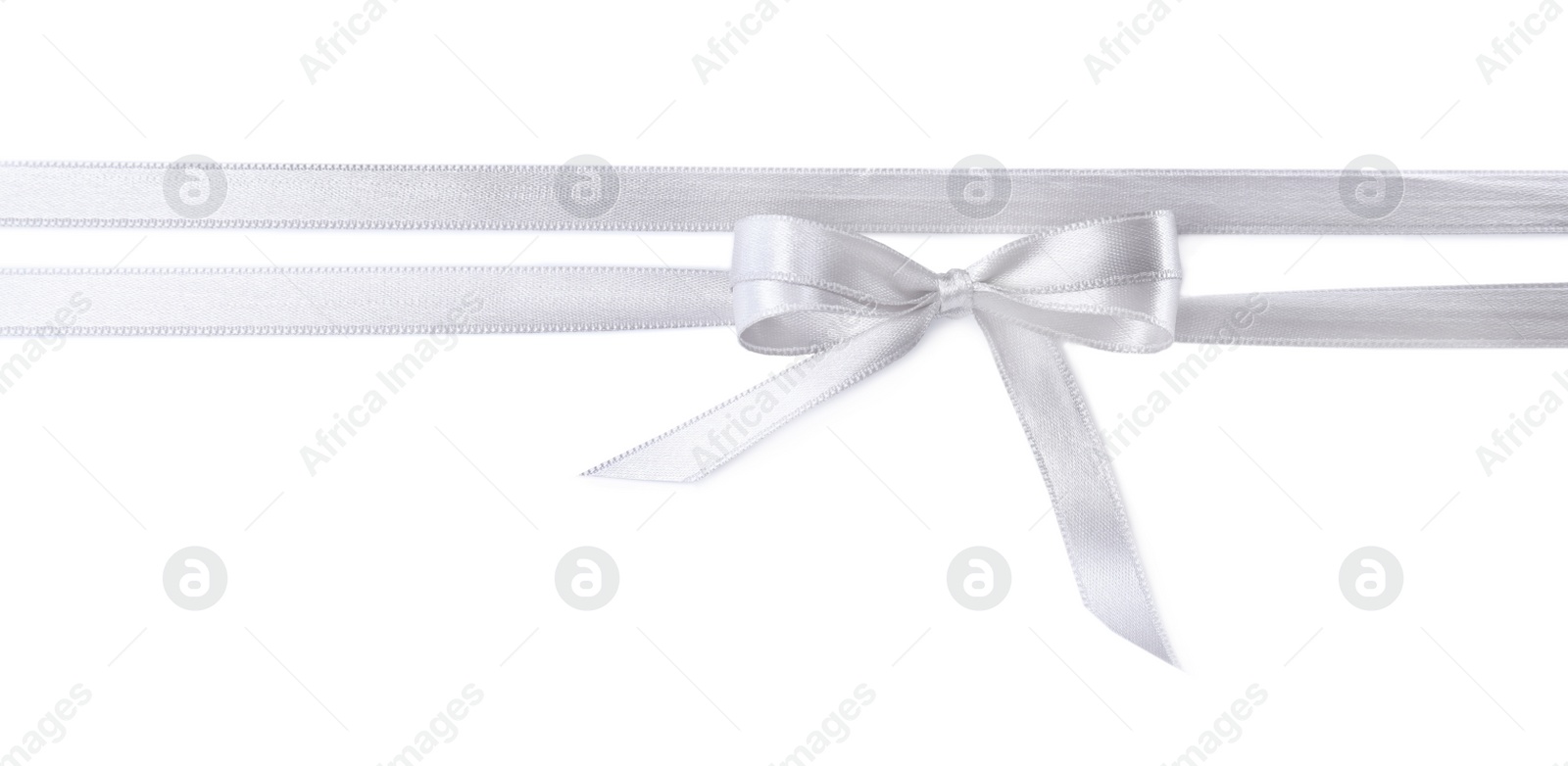 Photo of Silver satin ribbons with bow on white background, top view
