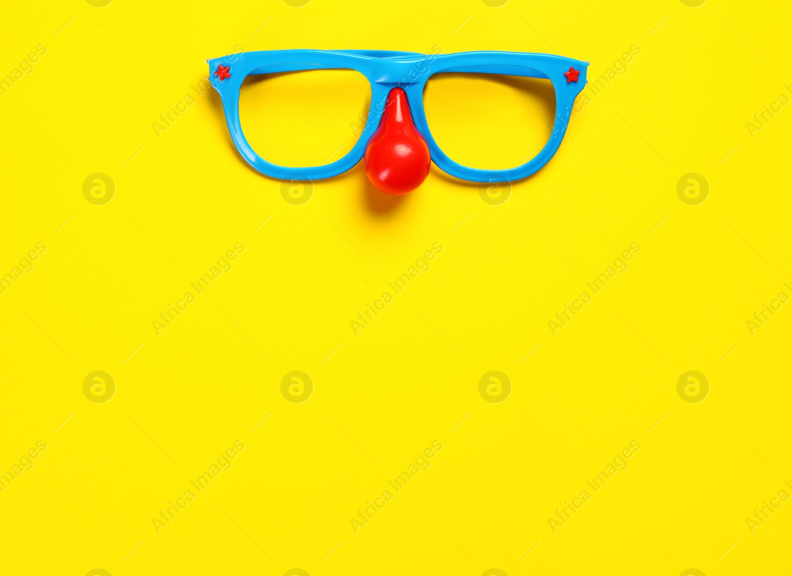 Photo of Masquerade glasses on colorful background, top view. Space for text