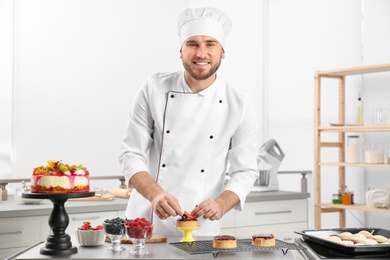 Male pastry chef preparing dessert at table in kitchen