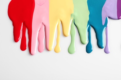 Photo of Spilled colorful nail polishes on white background