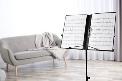 Note stand with music sheets indoors. Space for text