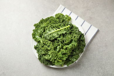 Fresh kale leaves on grey table, flat lay