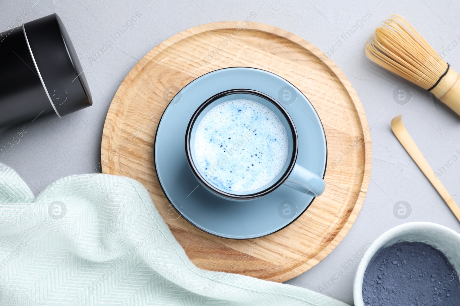 Image of Flat lay composition with blue matcha latte on grey table