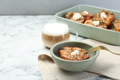 Photo of Tasty baked quinces with nuts and cream cheese on served white marble table. Space for text