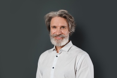 Photo of Portrait of handsome mature man on dark background