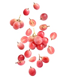 Fresh ripe grapes falling on white background