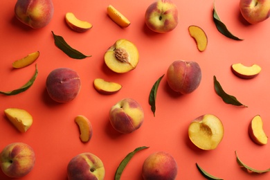 Photo of Flat lay composition with fresh peaches on coral background