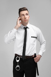 Photo of Male security guard in uniform on color background