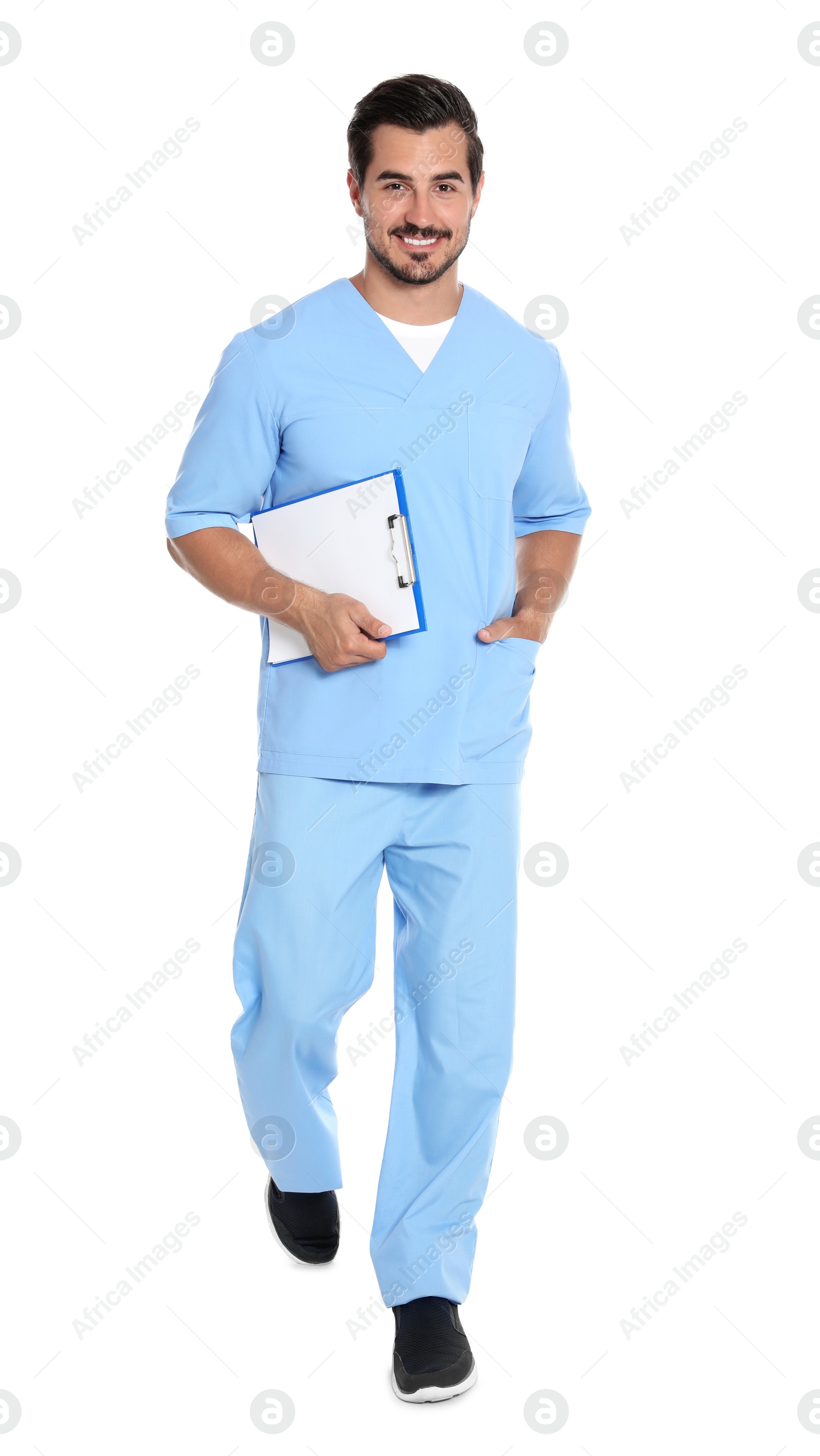 Photo of Young male doctor with clipboard walking on white background. Medical service