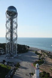 Photo of Batumi, Georgia - October 12, 2022: Picturesque view of Alphabetic Tower near sea