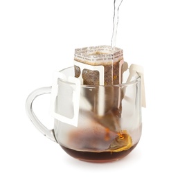 Photo of Pouring hot water into glass cup with drip coffee bag isolated on white