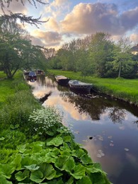 Photo of Beautiful view of canal with moored boats outdoors on spring day