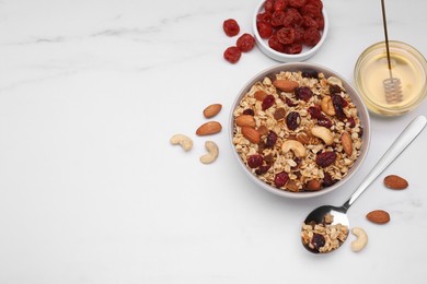 Photo of Tasty granola with nuts and dry fruits on white marble table, flat lay. Space for text