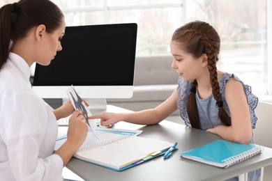 Little girl passing Rorschach test at child psychologist office