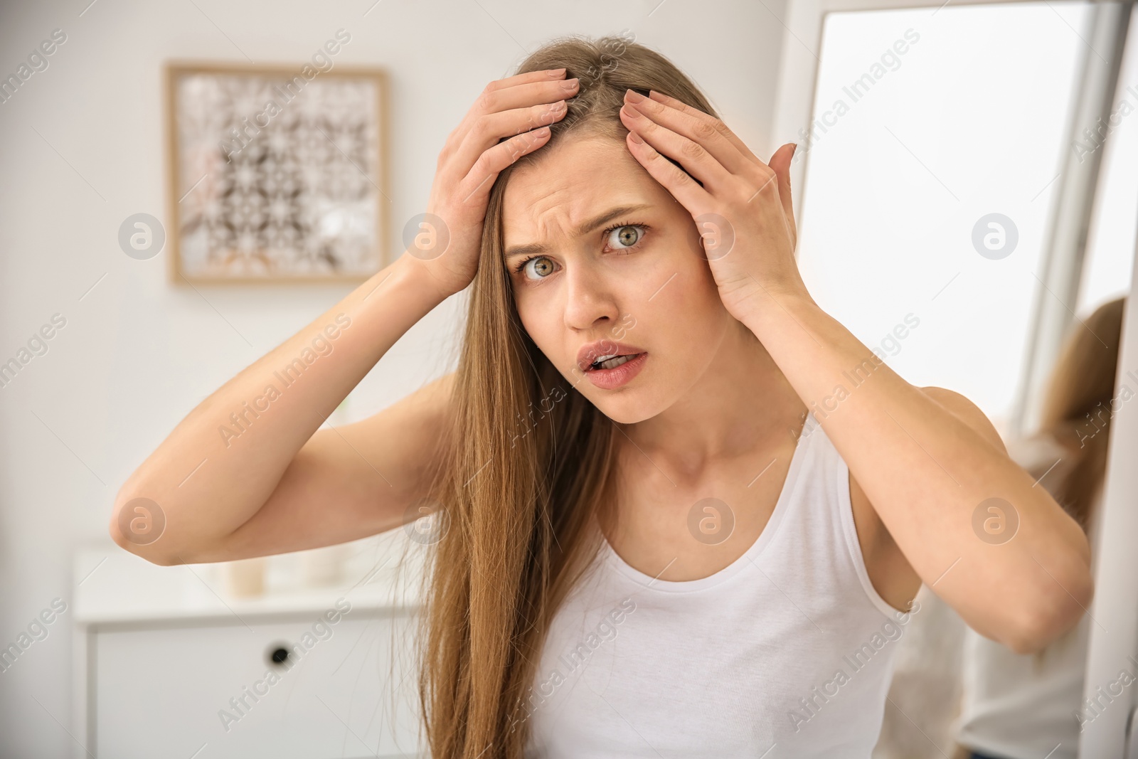 Photo of Young woman with hair loss problem indoors