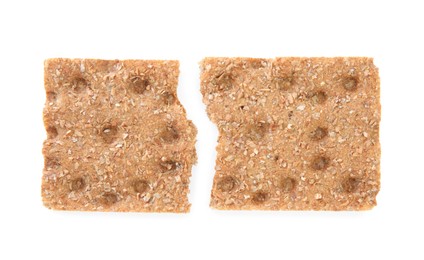 Photo of Halves of crunchy rye crispbread on white background, top view