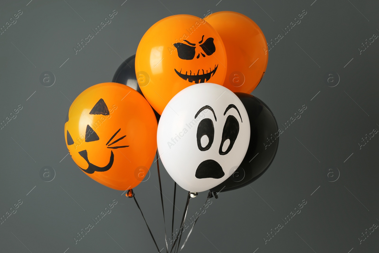 Photo of Color balloons for Halloween party on gray background