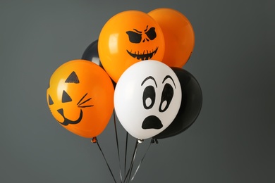 Photo of Color balloons for Halloween party on gray background