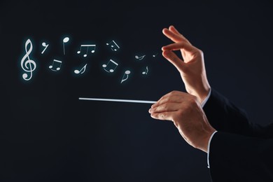 Image of Conductor with baton and music notes on dark background, closeup