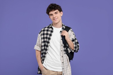 Photo of Portrait of student with backpack on purple background