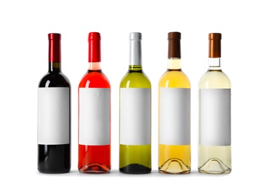 Photo of Bottles of delicious wines with blank labels on white background