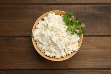 Photo of Delicious fresh cottage cheese on wooden table, top view