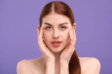 Photo of Portrait of beautiful woman with freckles on purple background