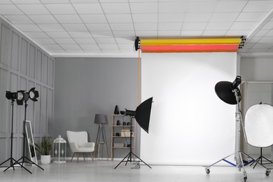 Photo of White photo background and professional lighting equipment in modern studio