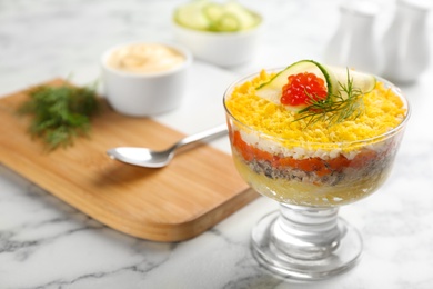 Photo of Traditional russian salad Mimosa served on white marble table. Space for text