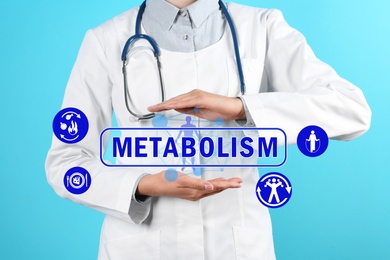 Image of Metabolism concept. Doctor with stethoscope on blue background, closeup
