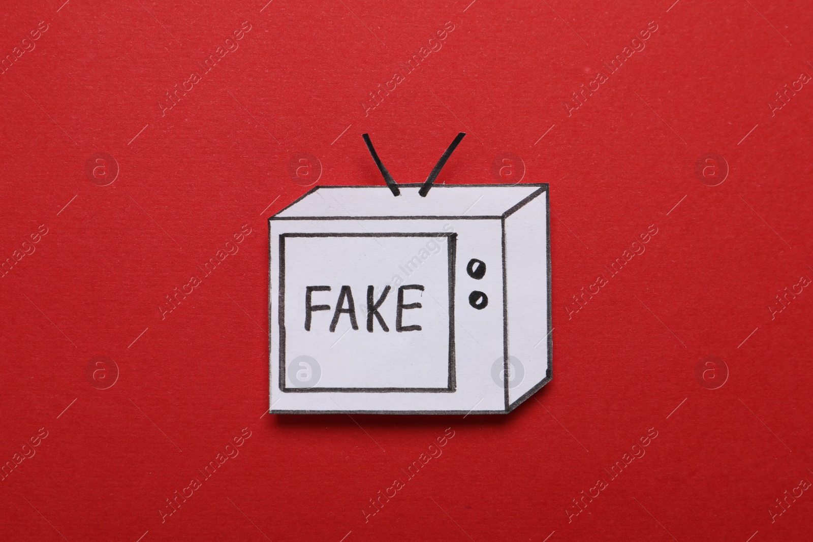 Photo of Paper TV with word Fake on red background, top view. Information warfare concept