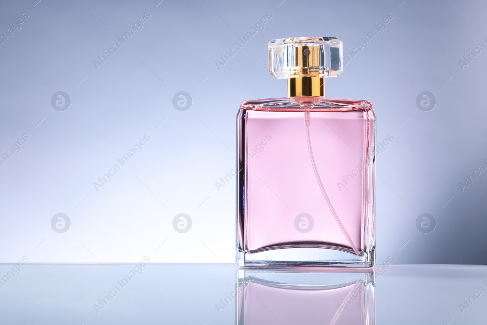 Photo of Luxury women's perfume in bottle on grey background. Space for text