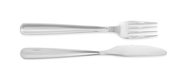 Photo of Knife and fork isolated on white, top view. Stylish shiny cutlery set