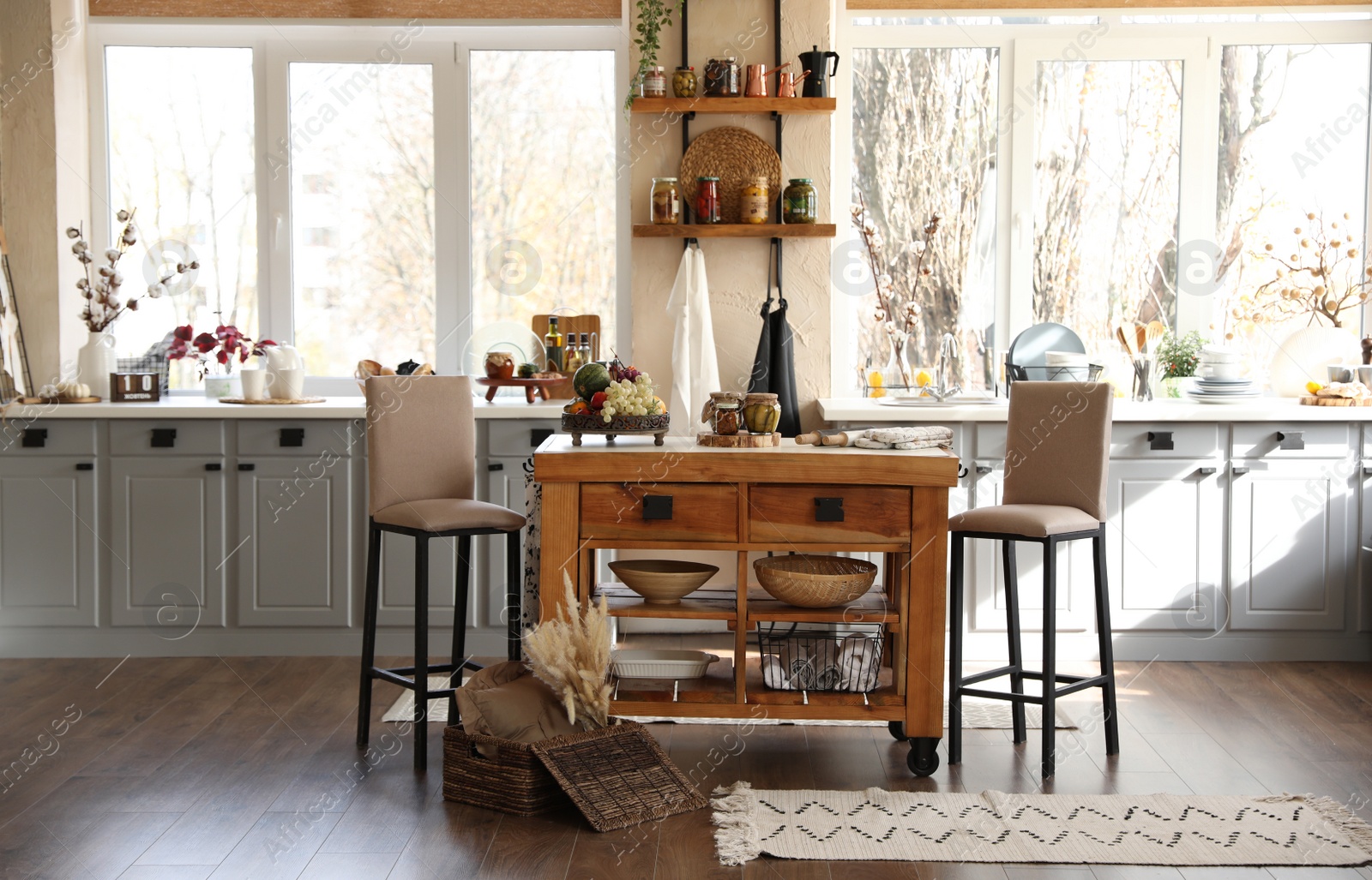 Photo of Stylish kitchen interior with wooden table and chairs