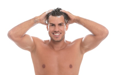 Photo of Handsome man washing hair on white background