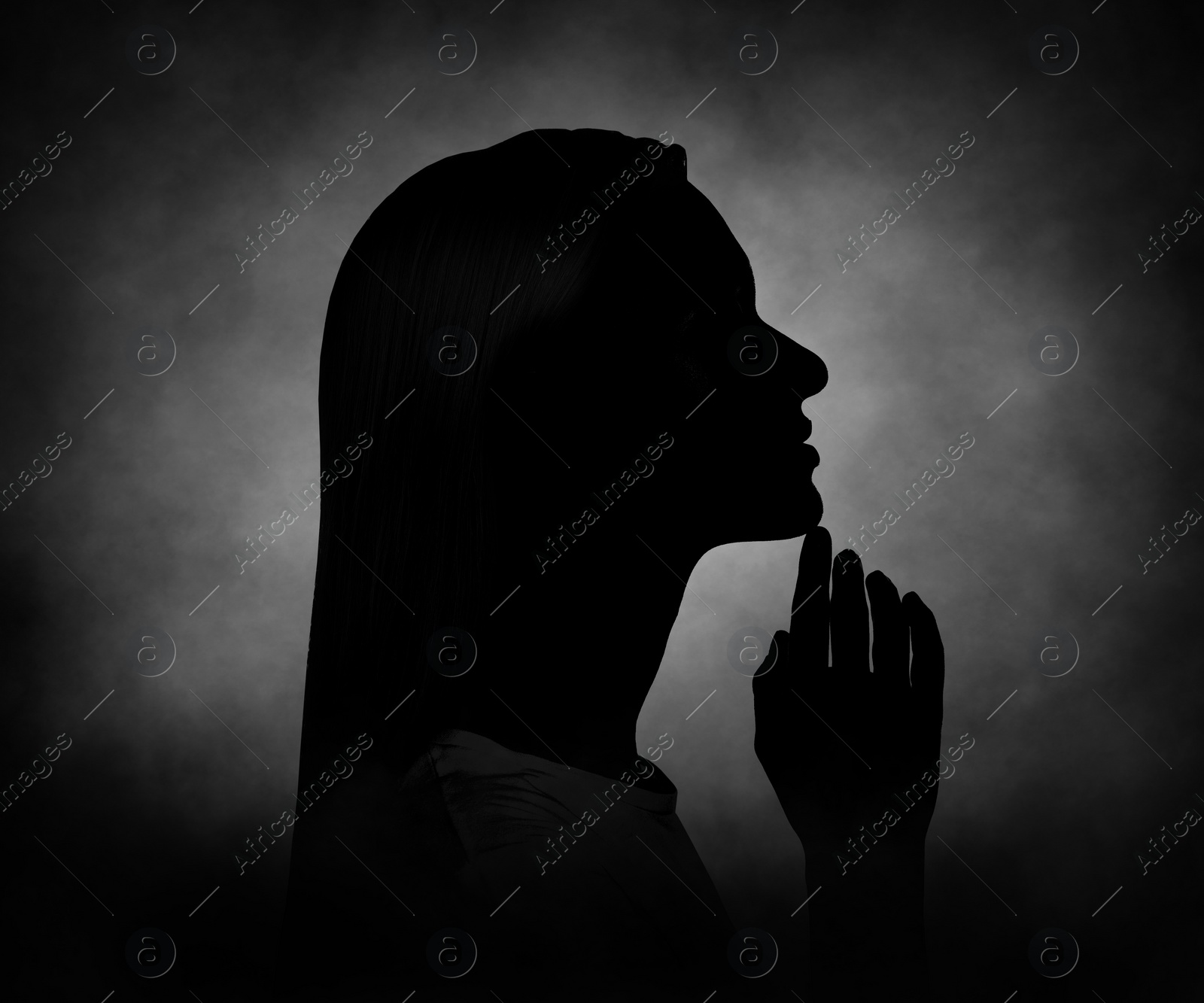 Image of Silhouette of woman in darkness. Portrait on black background