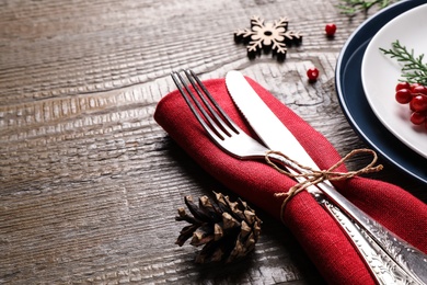 Photo of Beautiful Christmas table setting on wooden background, closeup