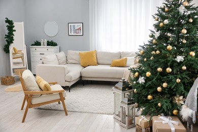 Photo of Christmas tree in furnished living room. Festive interior design