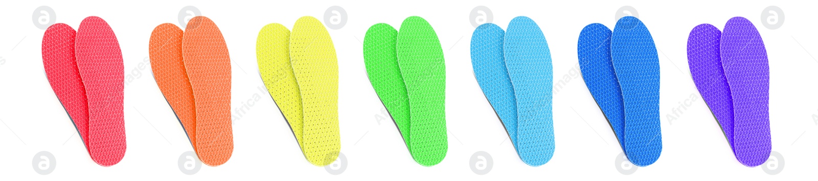 Image of Set with colorful orthopedic insoles on white background, top view. Banner design