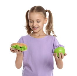 Photo of Happy girl holding sandwich and apple on white background. Healthy food for school lunch