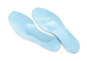 LIght blue orthopedic insoles isolated on white, top view