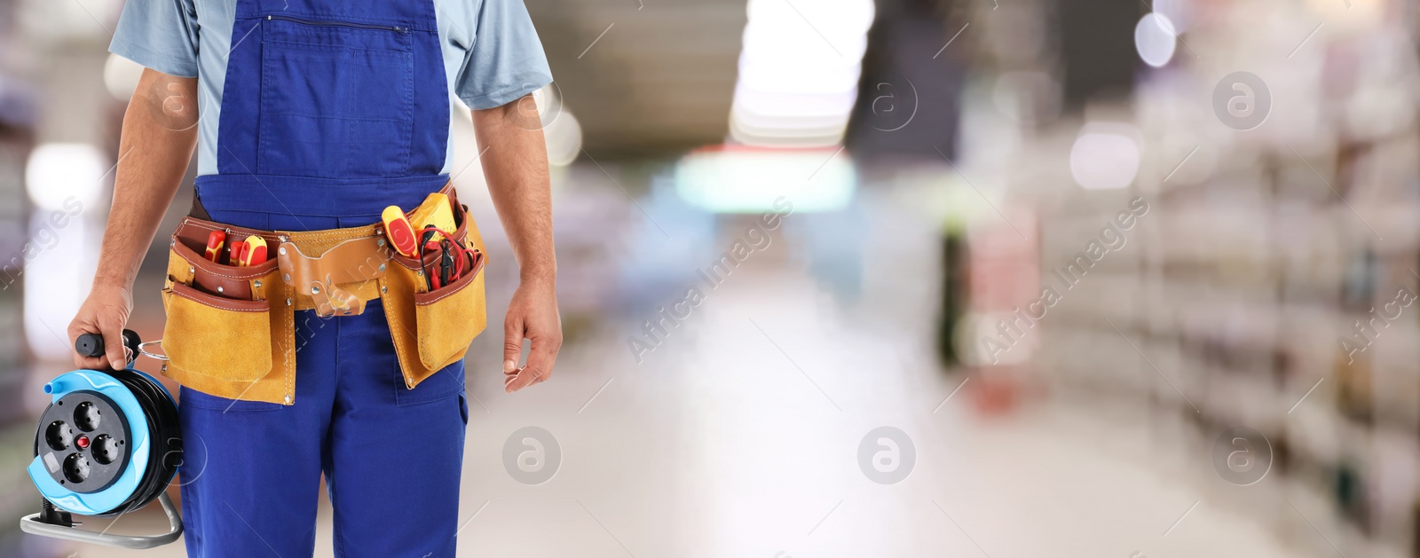 Image of Closeup view of electrician with tools at store, space for text. Banner design